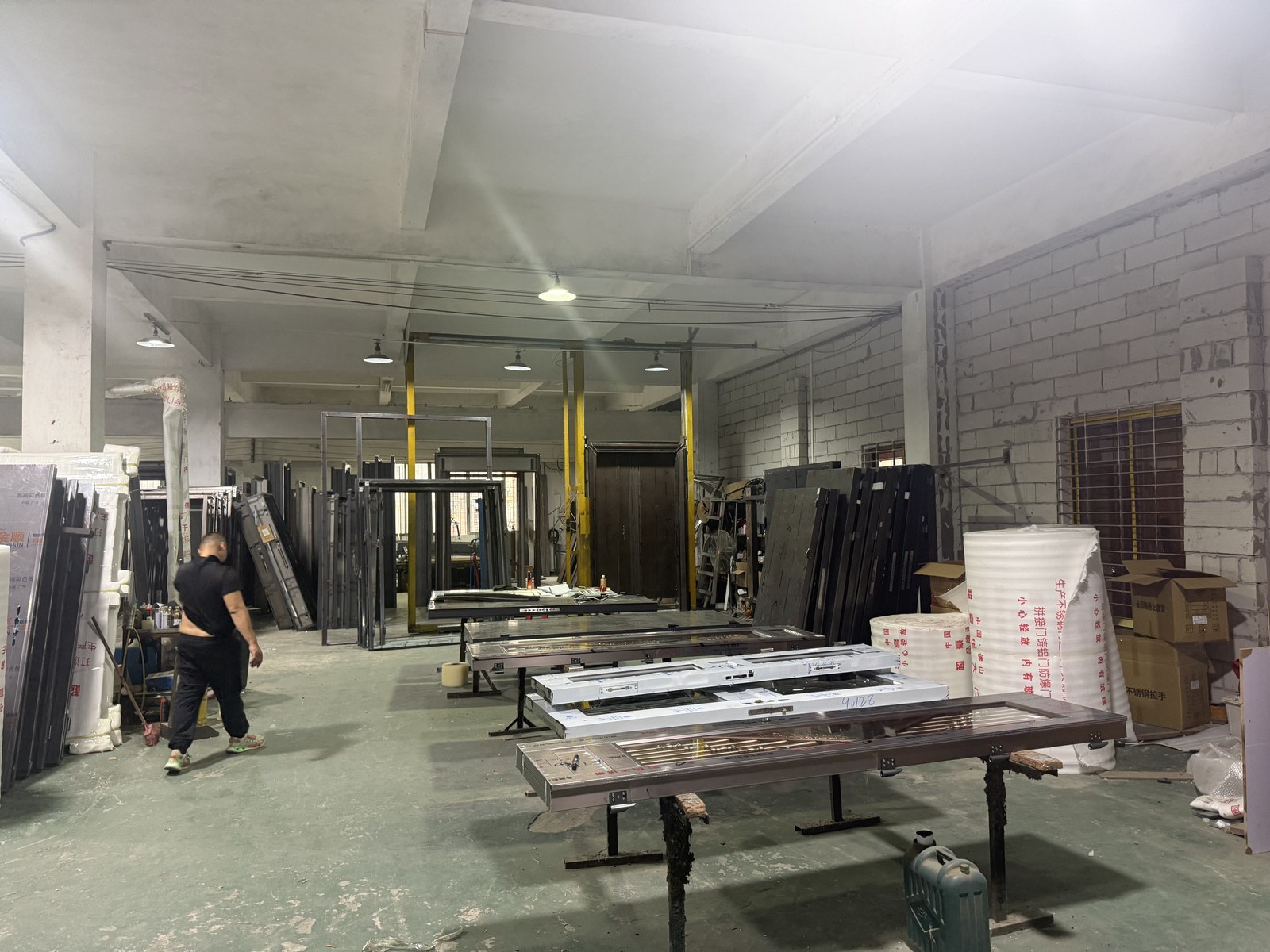 Production workshop with workers at machines, wide shot
